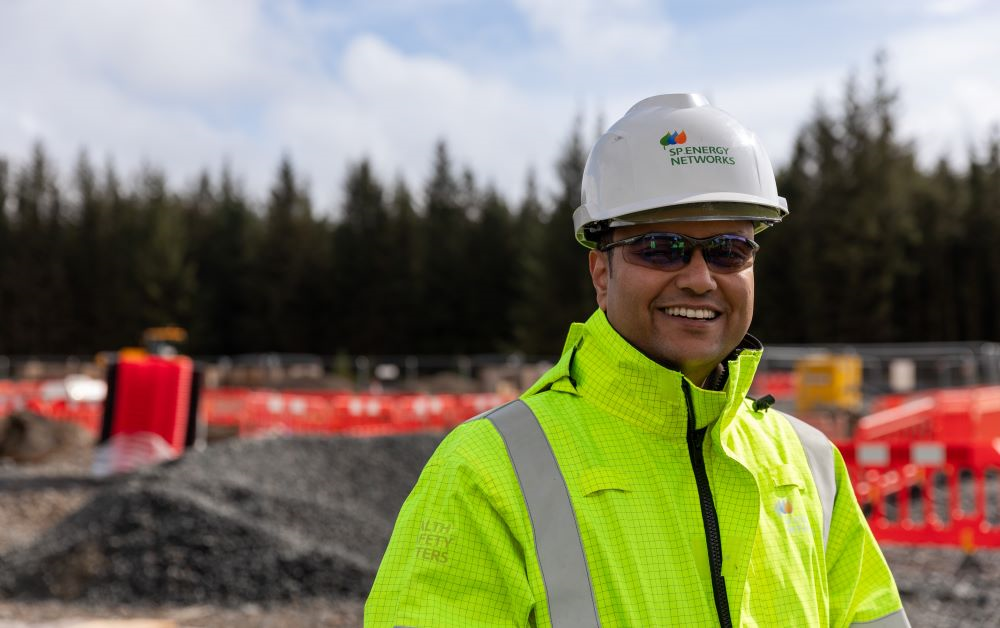 Smiling worker wearing high vis and hard hat PPE