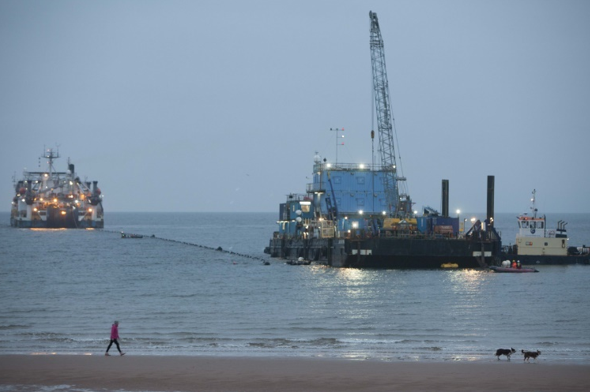 Cables being pulled ashore at Ardneil Bay in Scotland through ducts under the beach