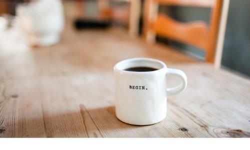 Photo of coffee cup with begin written on it