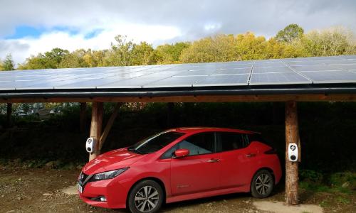 Photo of Solar Panels over a parked electric car