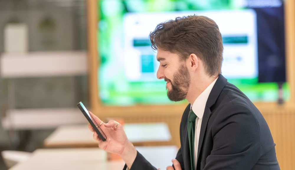 Office worker looking at mobile device